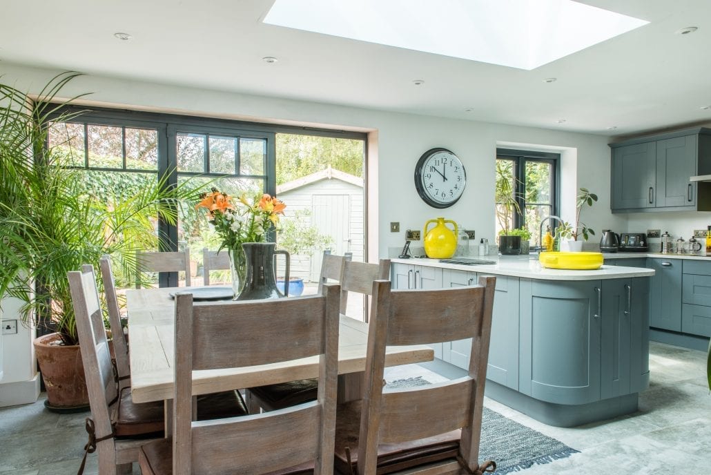 Bespoke bifolds with mullioned glazing and solid base panels on English cottage extension