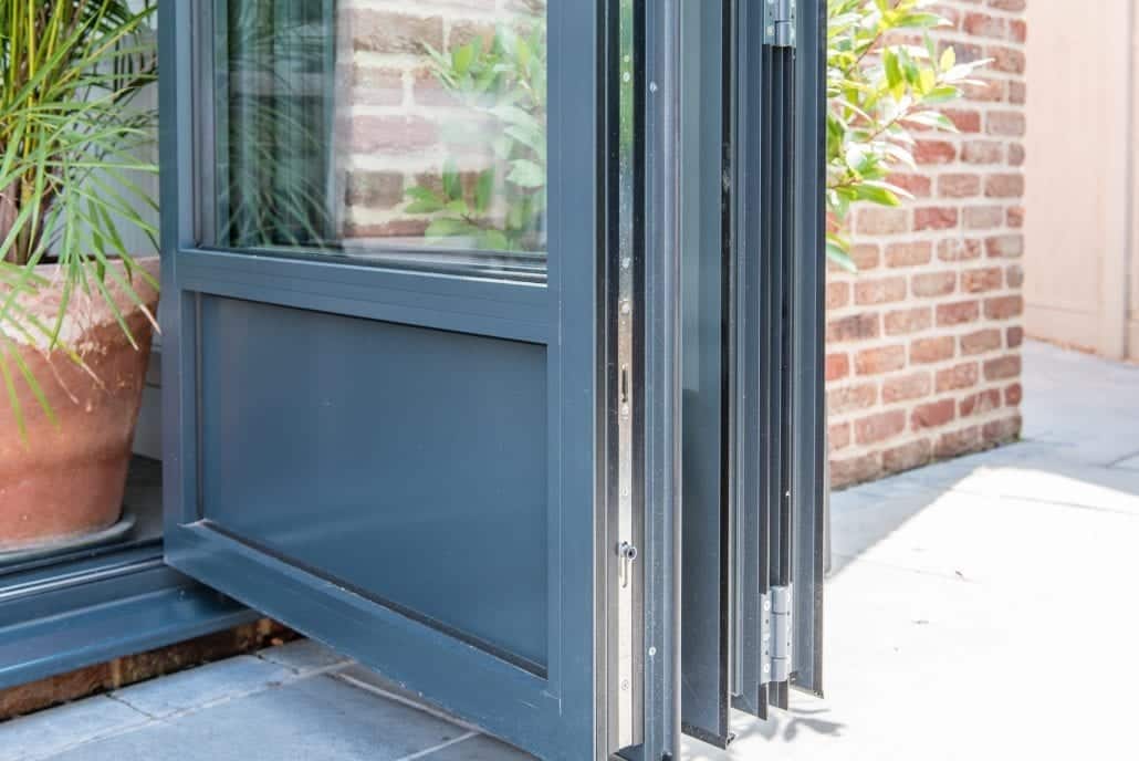 Bespoke French-inspired bifold doors on English cottage connecting to courtyard