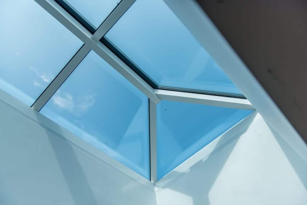 Roof lantern above kitchen extension with bifold doors open to garden