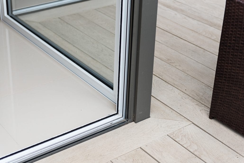 Interior view of aluminium bifold doors in an open plan kitchen-dining extension