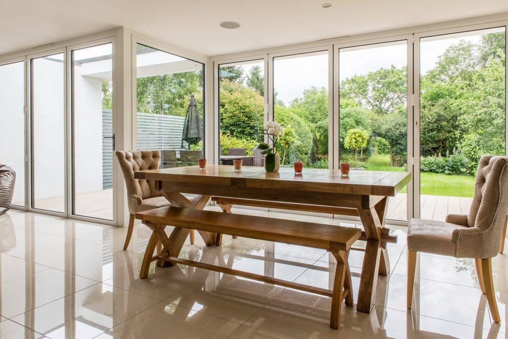 Aluminium bifold doors folded back to reveal the garden deck