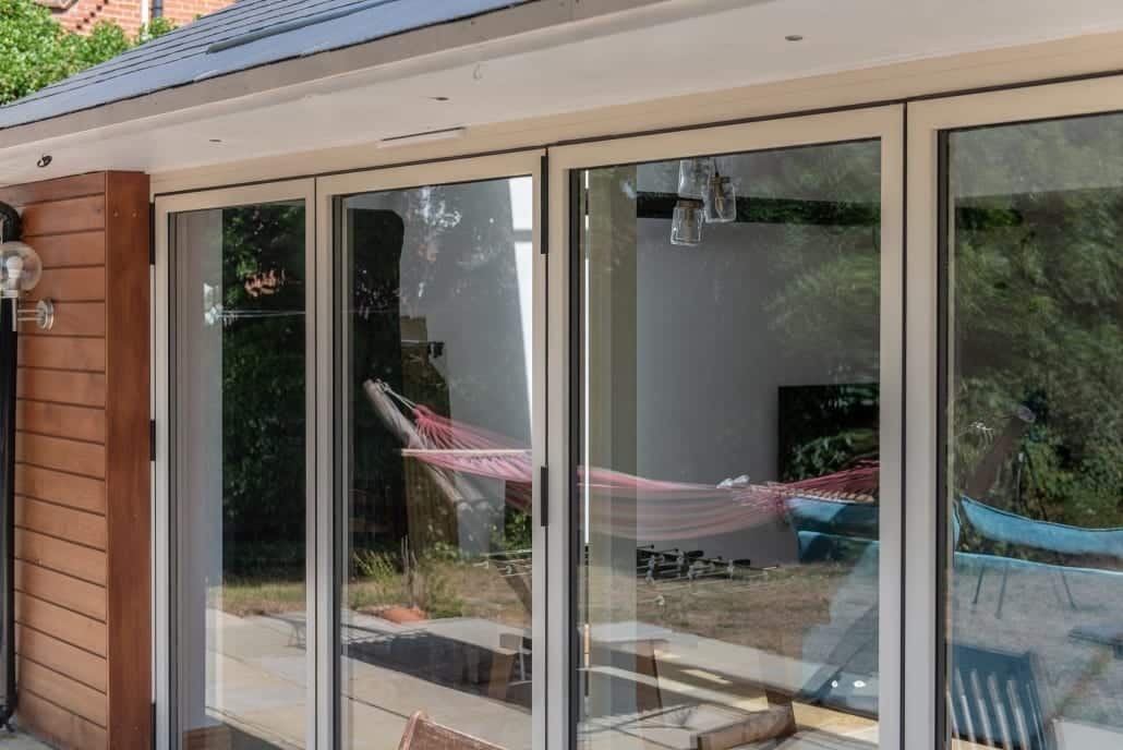 Open-plan kitchen with bifold doors connecting to garden