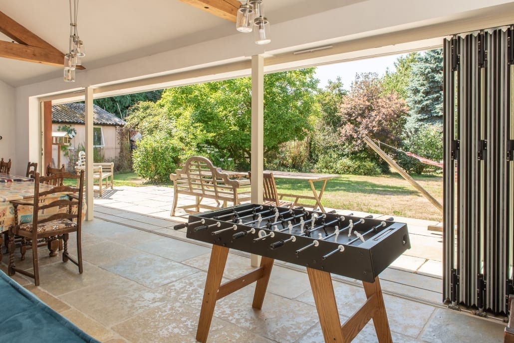 Aluminium bifold doors open wide on a rear extension, South Ipswich village