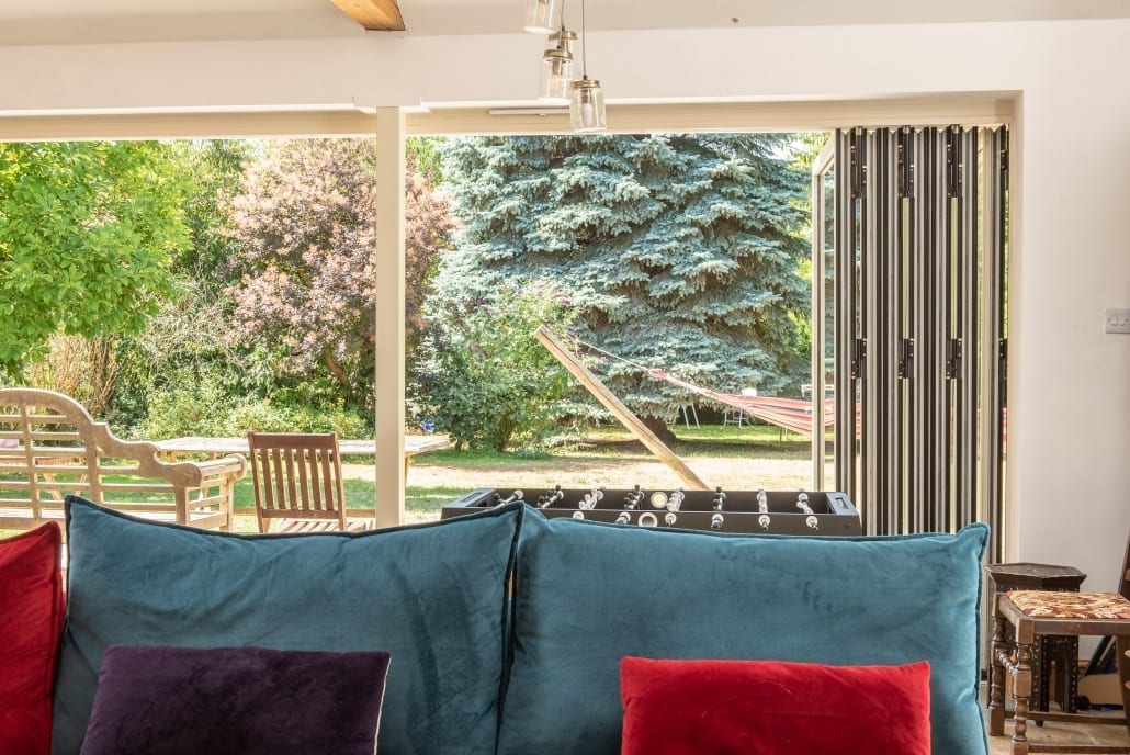 Interior view through aluminium bifold doors to garden, Open House project