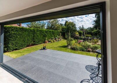 Minimal aluminium frame sliding doors connecting interior to garden