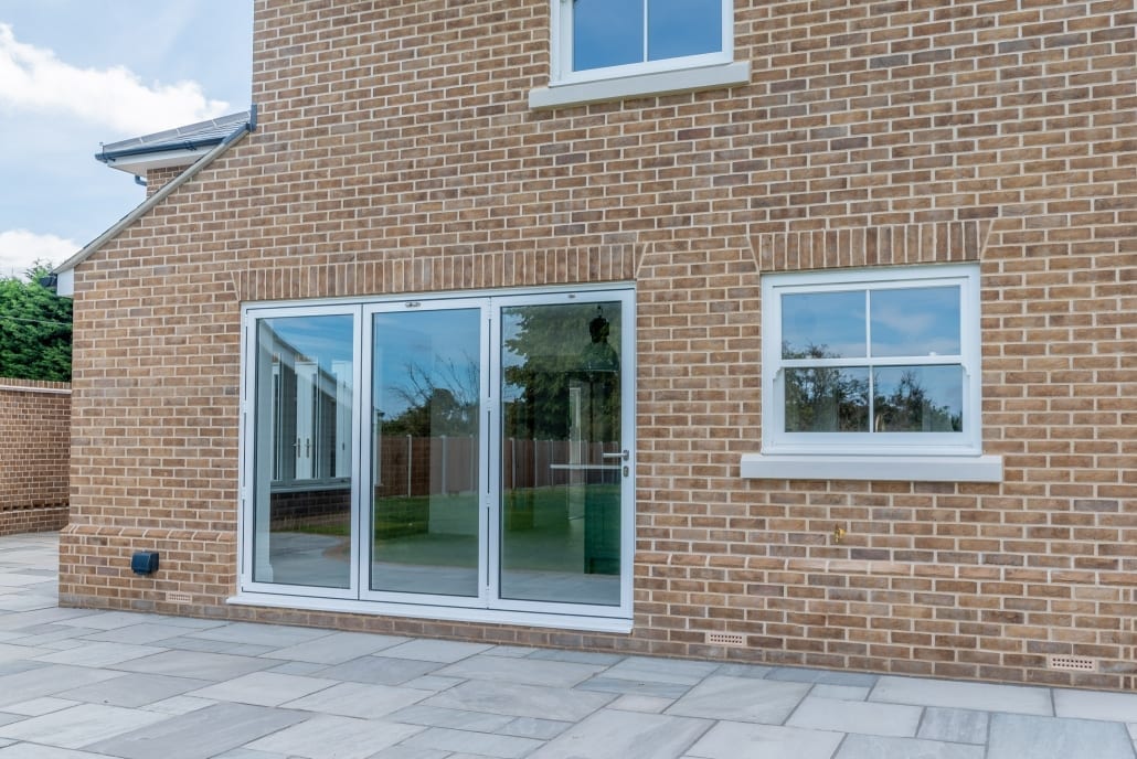 Kitchen living area with natural light and bifold doors open to garden