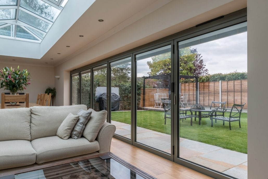 Bifold doors stacked at the sides with full opening to the garden