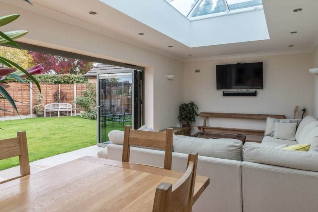 Extension interior with natural light from lantern roof and bifold doors open