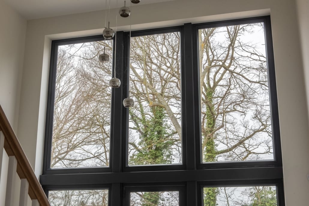 Tall Origin aluminium glazed screen to stairwell, Essex installation