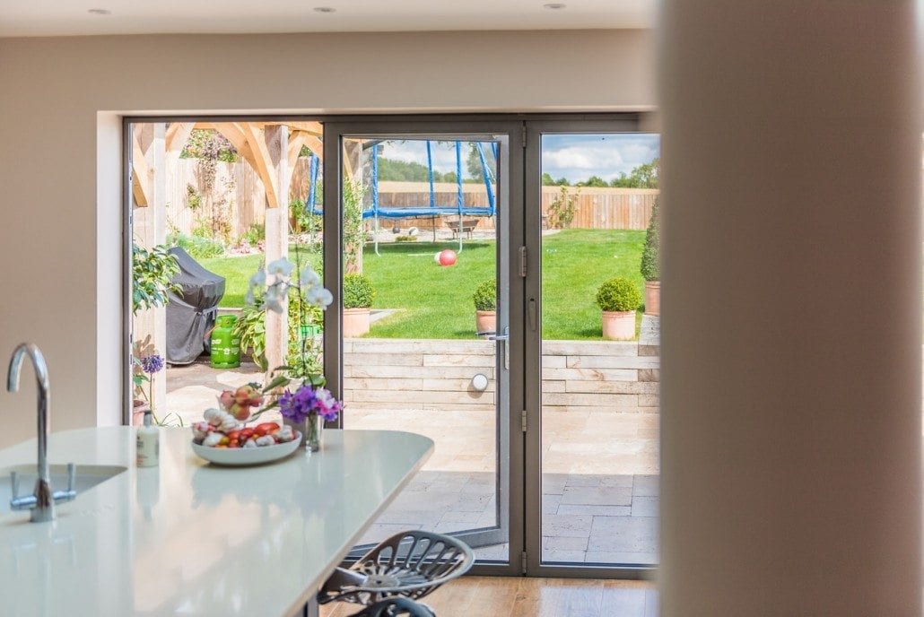 Interior view of open-plan kitchen and dining area with roof lanterns above