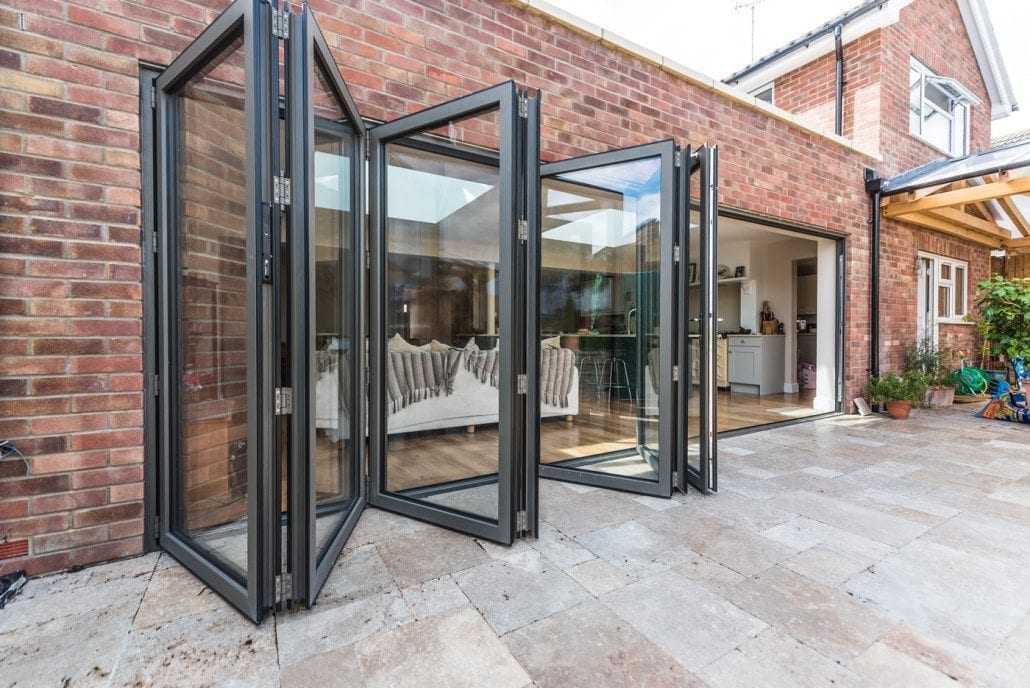 Seamless floor-to-patio transition through open bifold doors