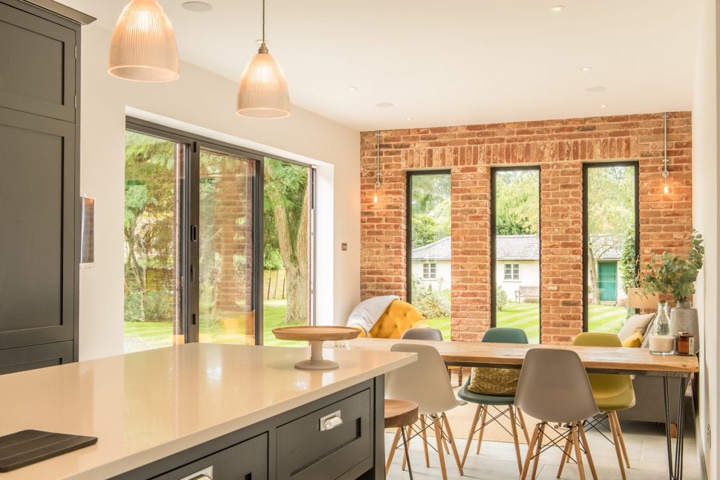 Black powder-coated aluminium bifold doors on the rear extension of a double-fronted Colchester property