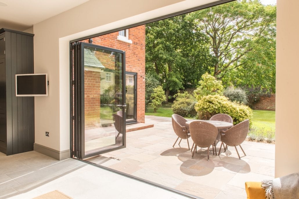 Close-up of black aluminium bifold door frame and glazing on the rear extension