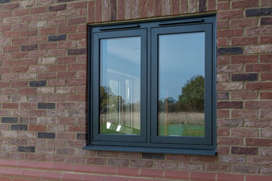 Side elevation of Essex village renovation showing anthracite flush sash windows