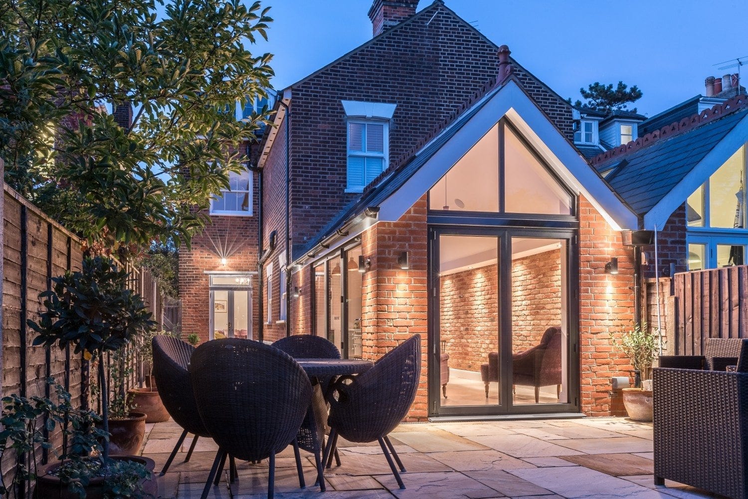 Wide view of Colchester Edwardian bifold door installation with brickwork and glazing