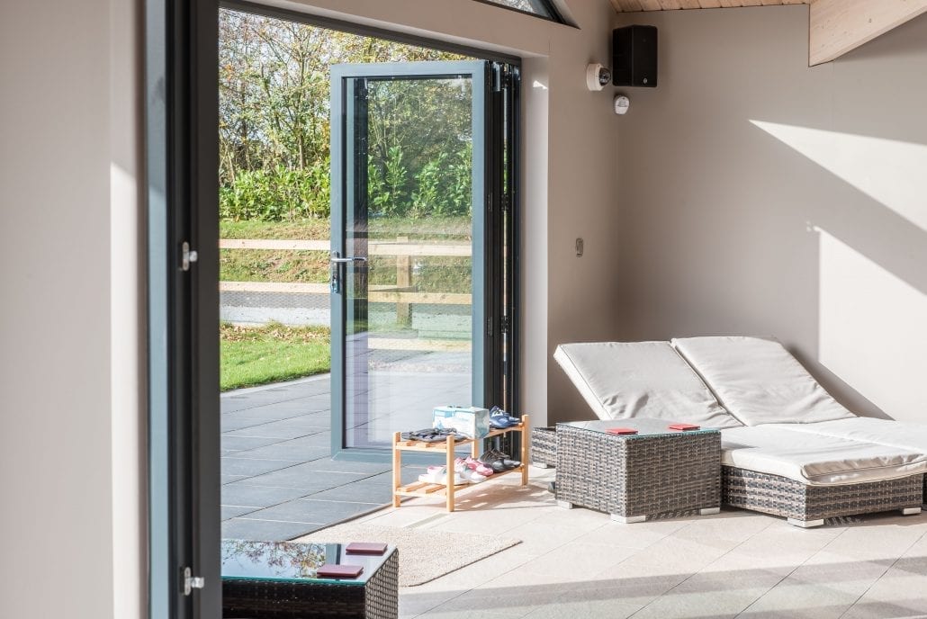 Bifold and sliding doors to the pool leisure building, Essex village renovation