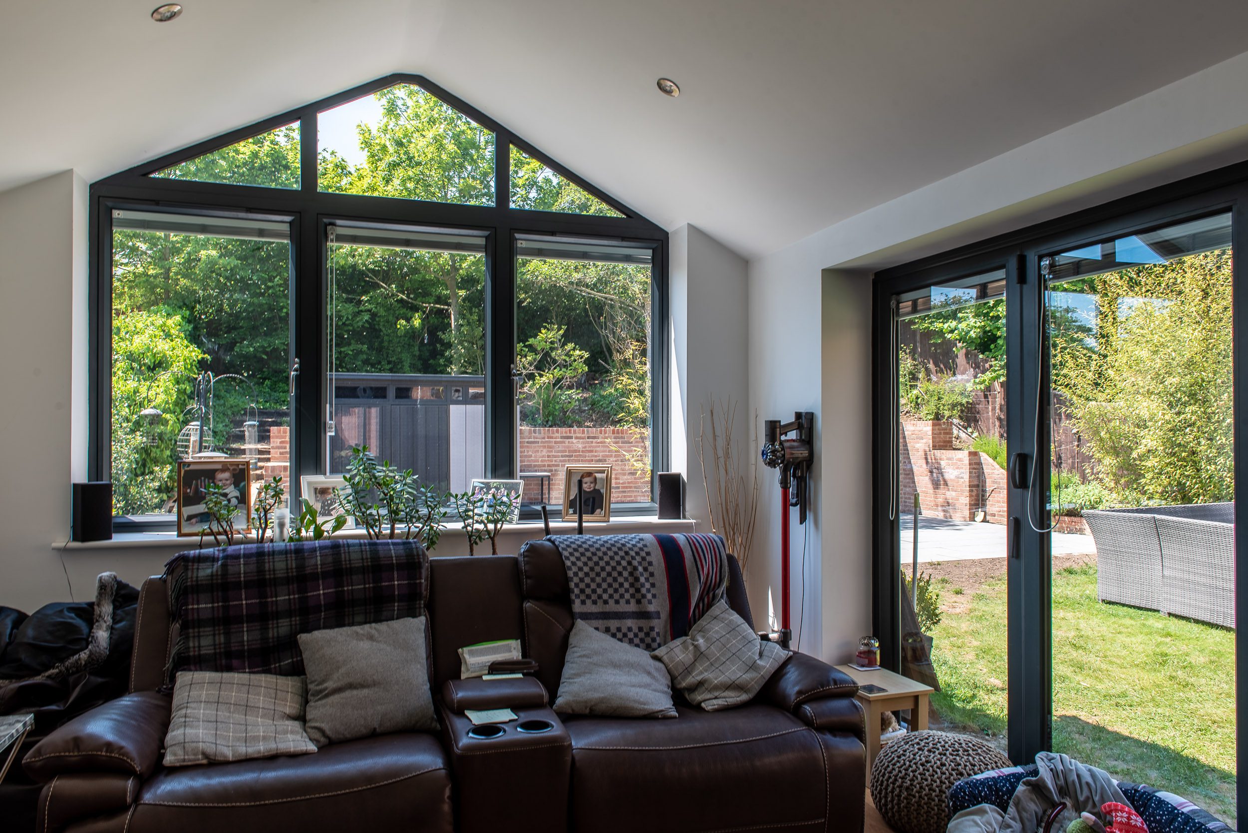 Large Origin aluminium window in a brick and standing-seam clad gable