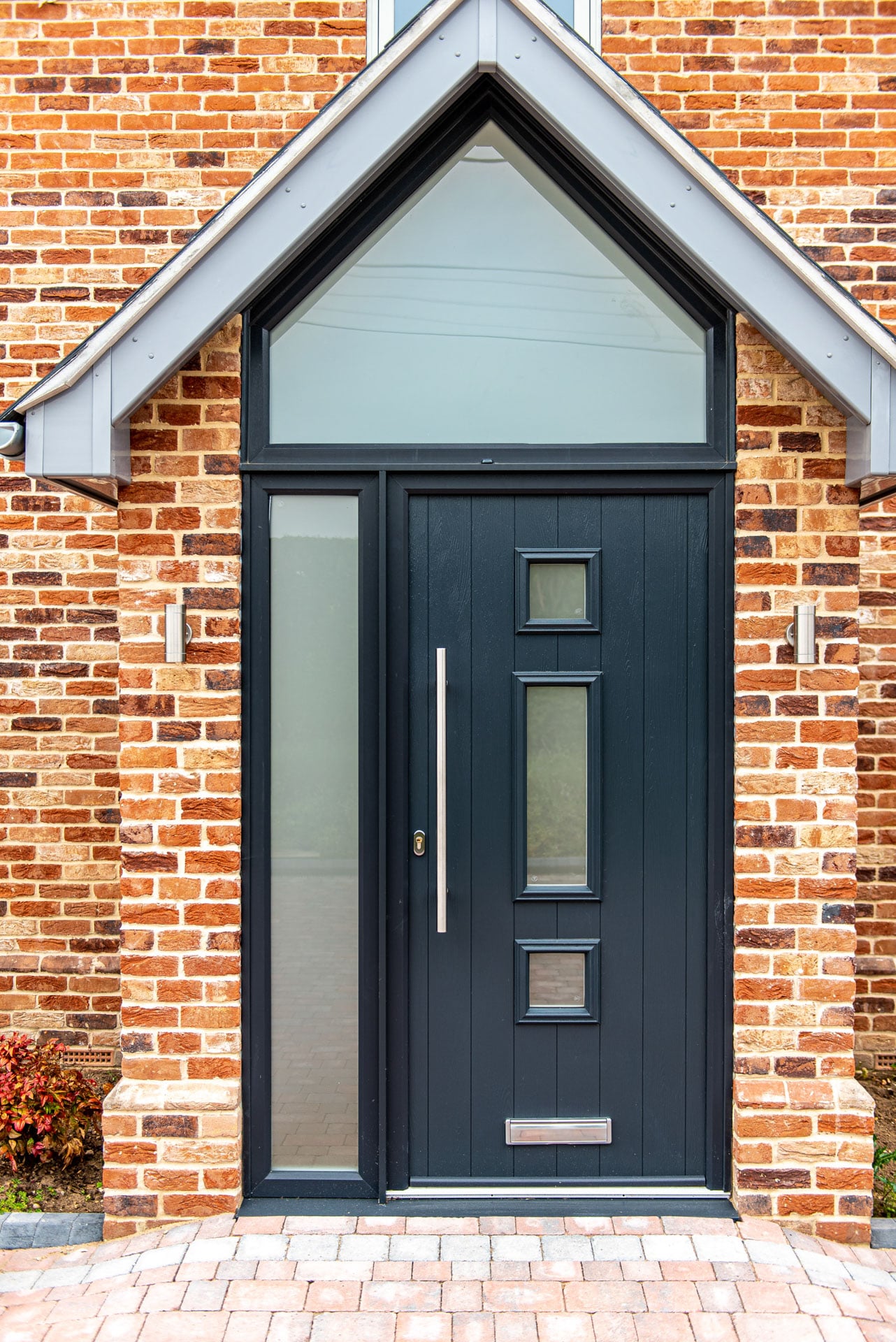 Grey Solidor composite door with decorative leaded glass panels on showroom display