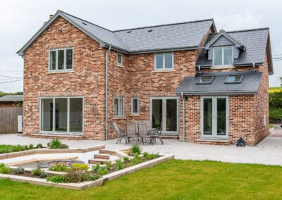 Red brick home with white uPVC windows and french doors, Windows Etc