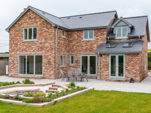 Exterior view of a newly built Suffolk property with traditional stock brickwork and contemporary glazing