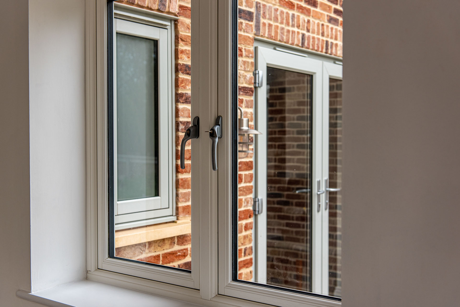 Anthracite casement window with shutters in brick gable, Essex