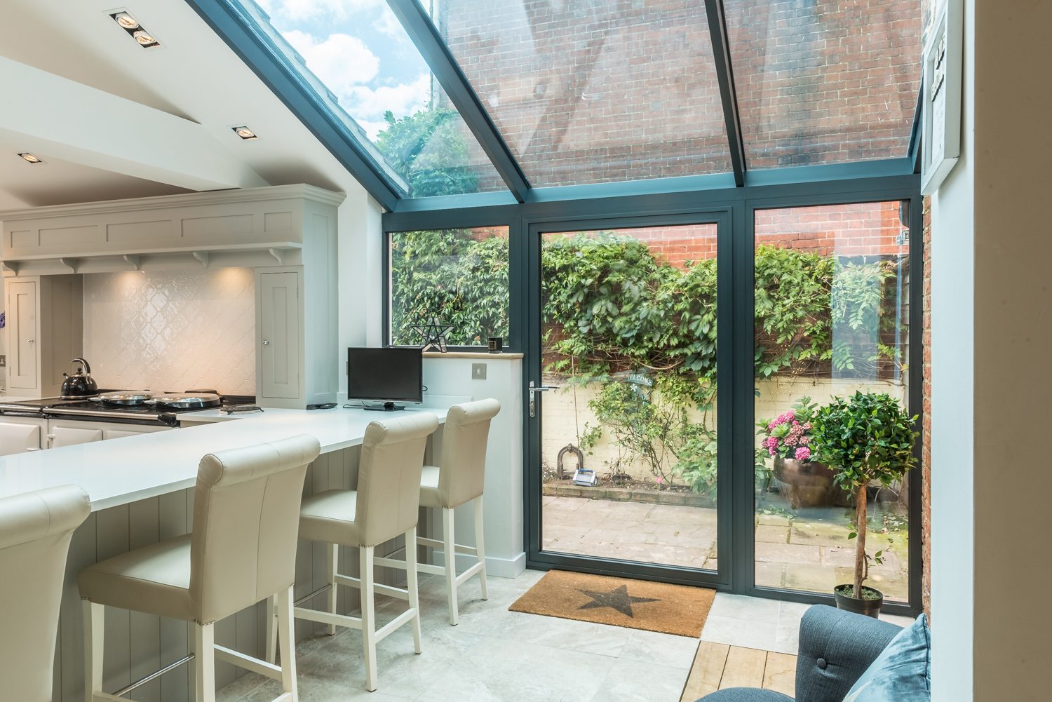 Modern shaker kitchen with lean-to glazed extension beyond