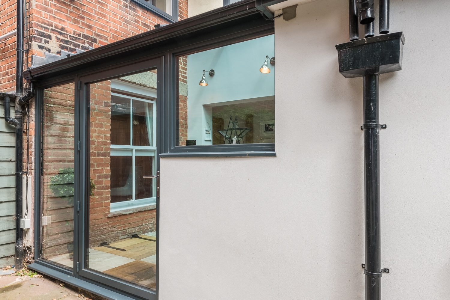 Glazed lean-to with airy courtyard feel, family home extension