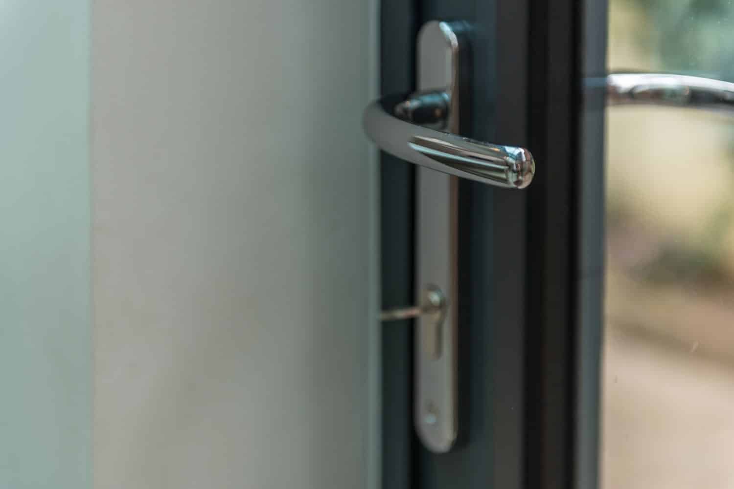 Anthracite lean-to glass panels against original house walls
