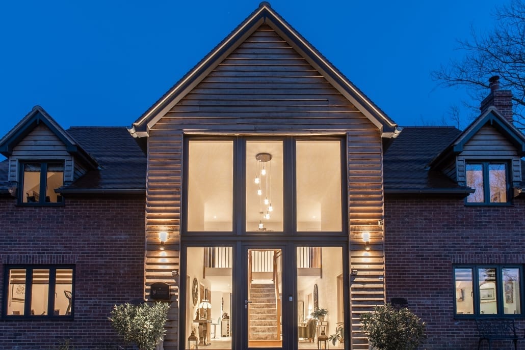 Origin aluminium glazing lit at dusk, north Colchester