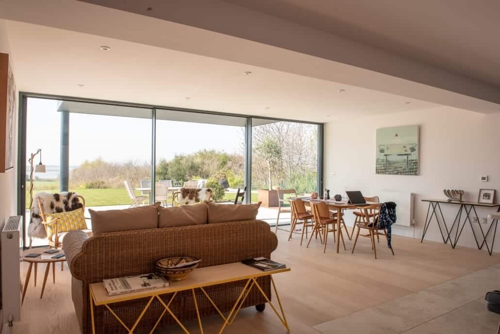 Aluminium sliding door open onto a patio and lawn