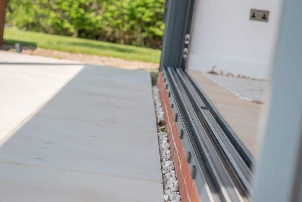 Window seat and three-panel aluminium windows on the Suffolk coast home