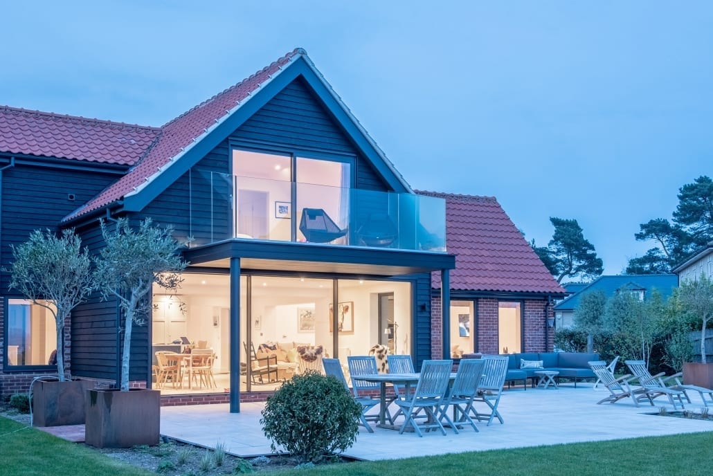 Interior view through Origin aluminium sliding doors to Suffolk estuary