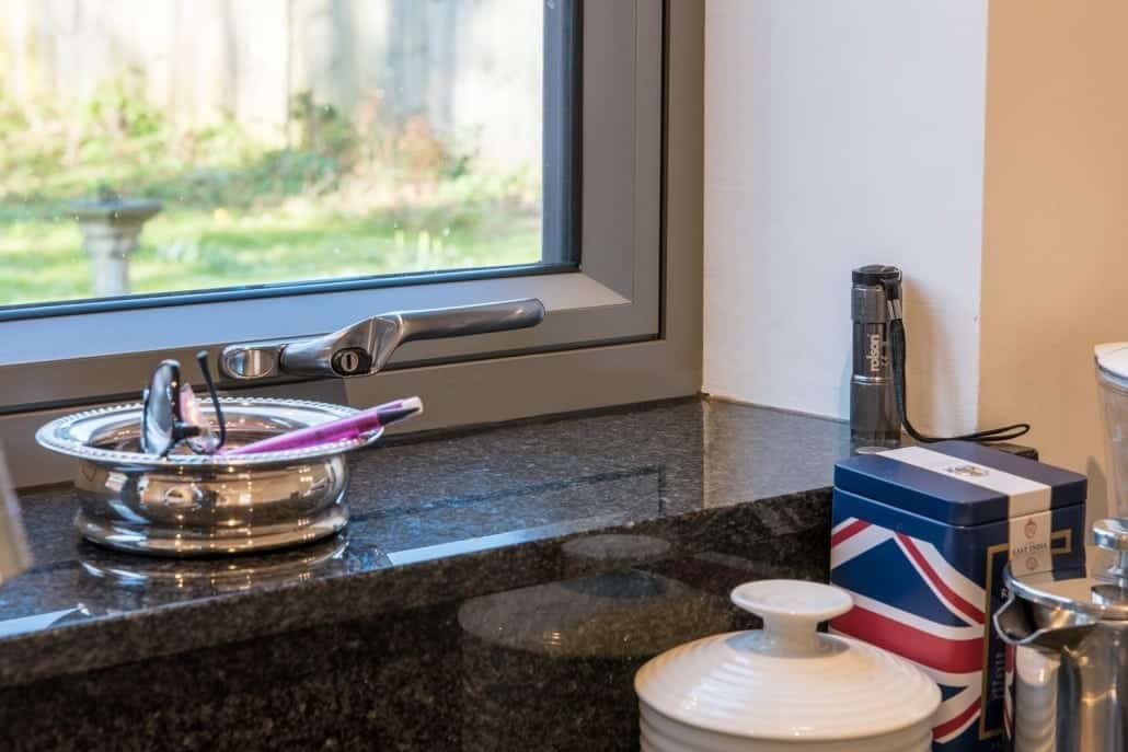 Origin aluminium flush sash windows and aïr sliding doors on a 1990s detached house