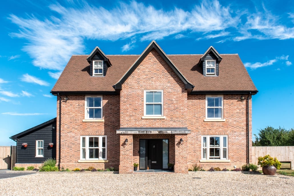 Red brick home with uPVC sliding sash windows and dormers, Essex