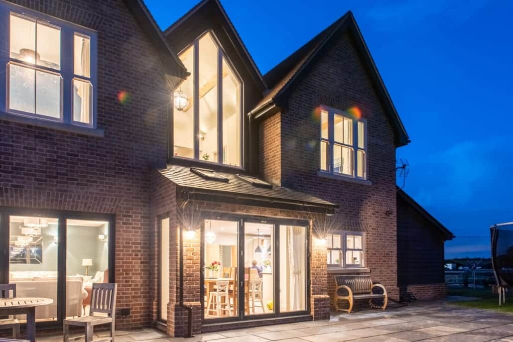 Farmhouse rear elevation with aluminium bifolds and fixed glazing frames