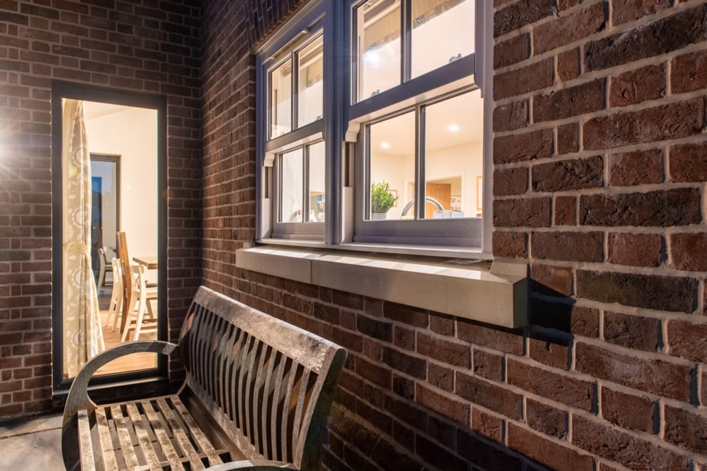 Close view of Smarts bifold doors open to garden on farmhouse rear elevation