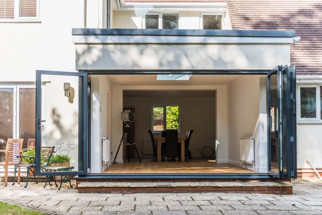 Grey aluminium bifold doors with egress door panel, conservatory replacement Kelvedon