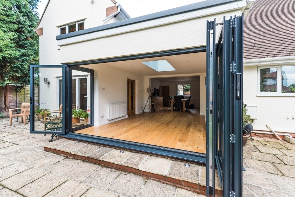 Exterior view of grey aluminium bifold doors and lantern roof in Kelvedon