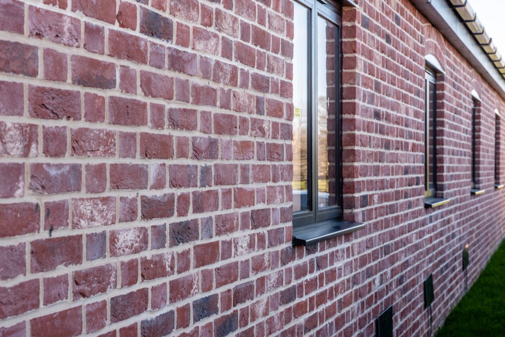 RAL 9005 matt black aluminium windows on red brick barn converted to offices
