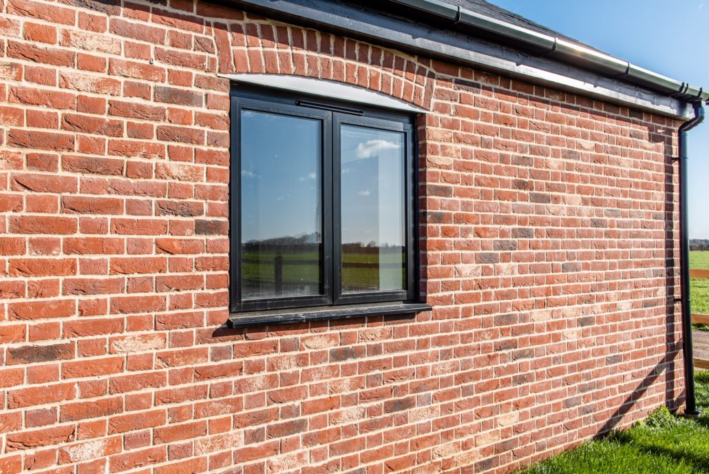 Gable glazing above bifold doors on a converted barn commercial unit