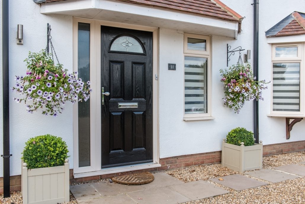 Rear garden view back towards the rebuilt home with bi-folding doors