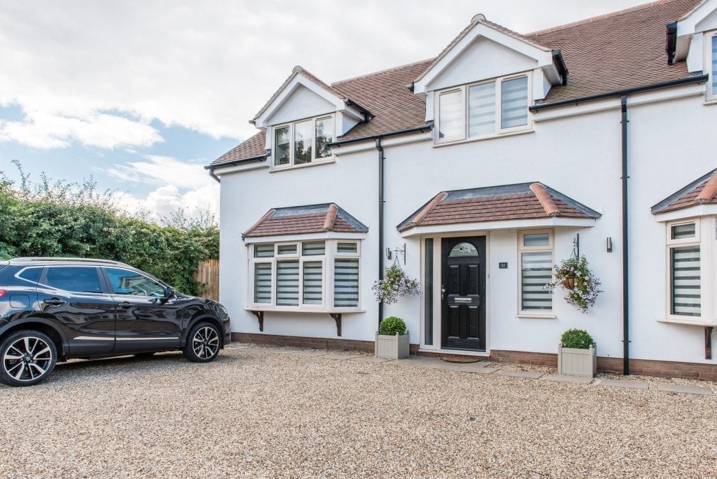 Full rear elevation of rebuilt home showing glazing and Juliette balcony
