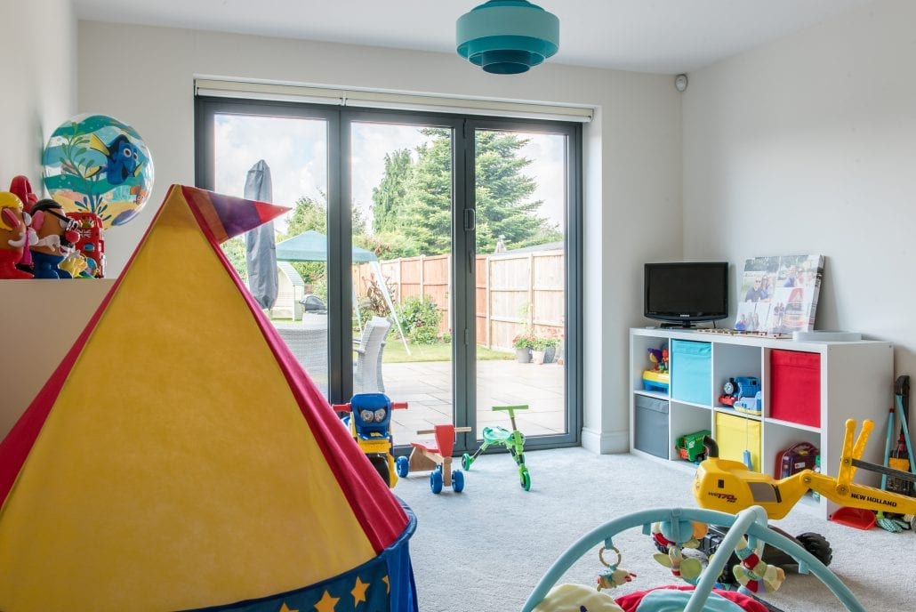 Bi-folding doors fully open revealing open-plan living space to rear garden
