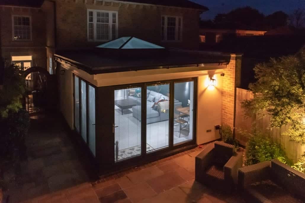 Bifold doors and roof lantern on a Colchester orangery-styled day-room, photographed at night