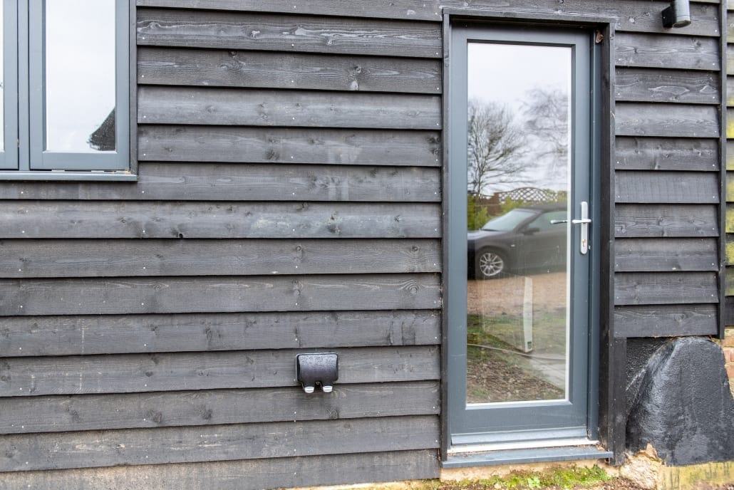 Side elevation of barn with Bereco French doors and floor-to-ceiling glazing