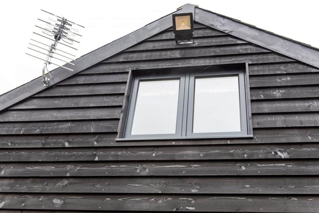 Timber barn exterior with flush sash windows and cream interior finish
