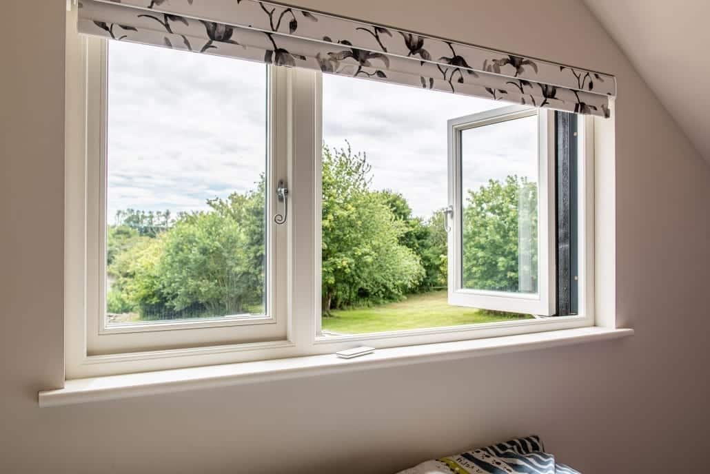 Smarts anthracite aluminium bifold doors on renovated timber barn exterior