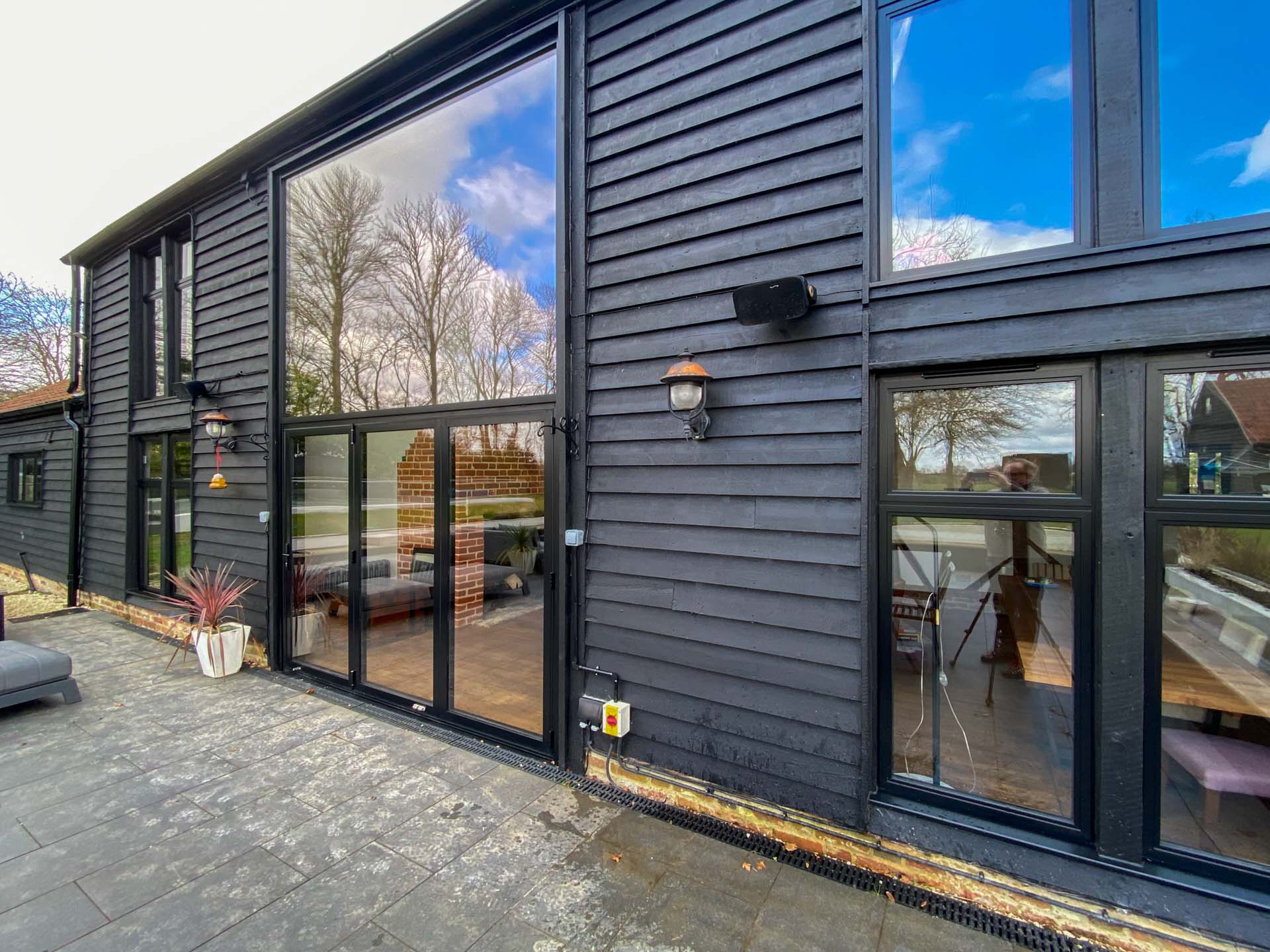 Seniors curtain wall screen with lower aluminium bifold doors, open-plan living area