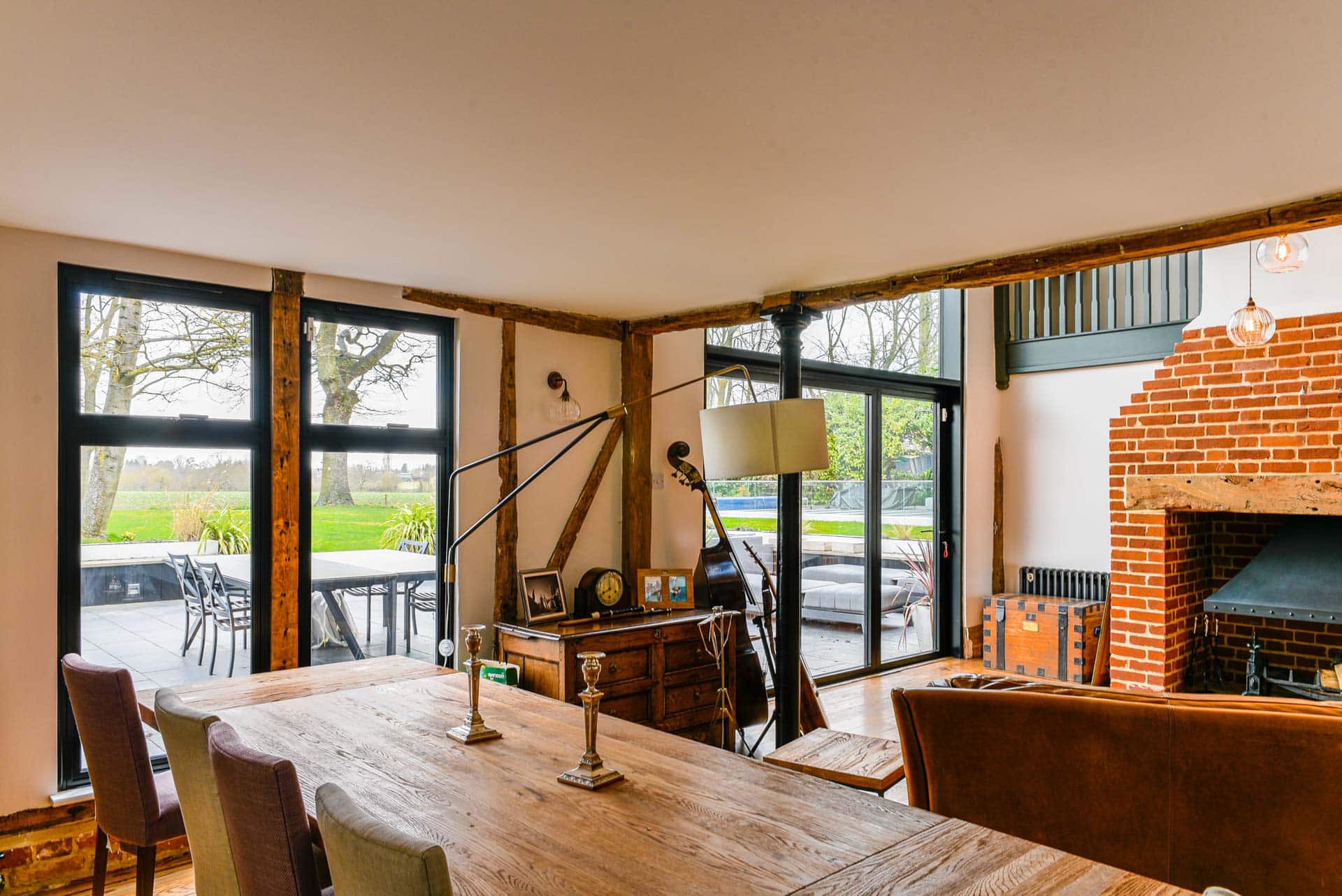 Interior view of curtain wall and bifold doors flooding open-plan living space with light