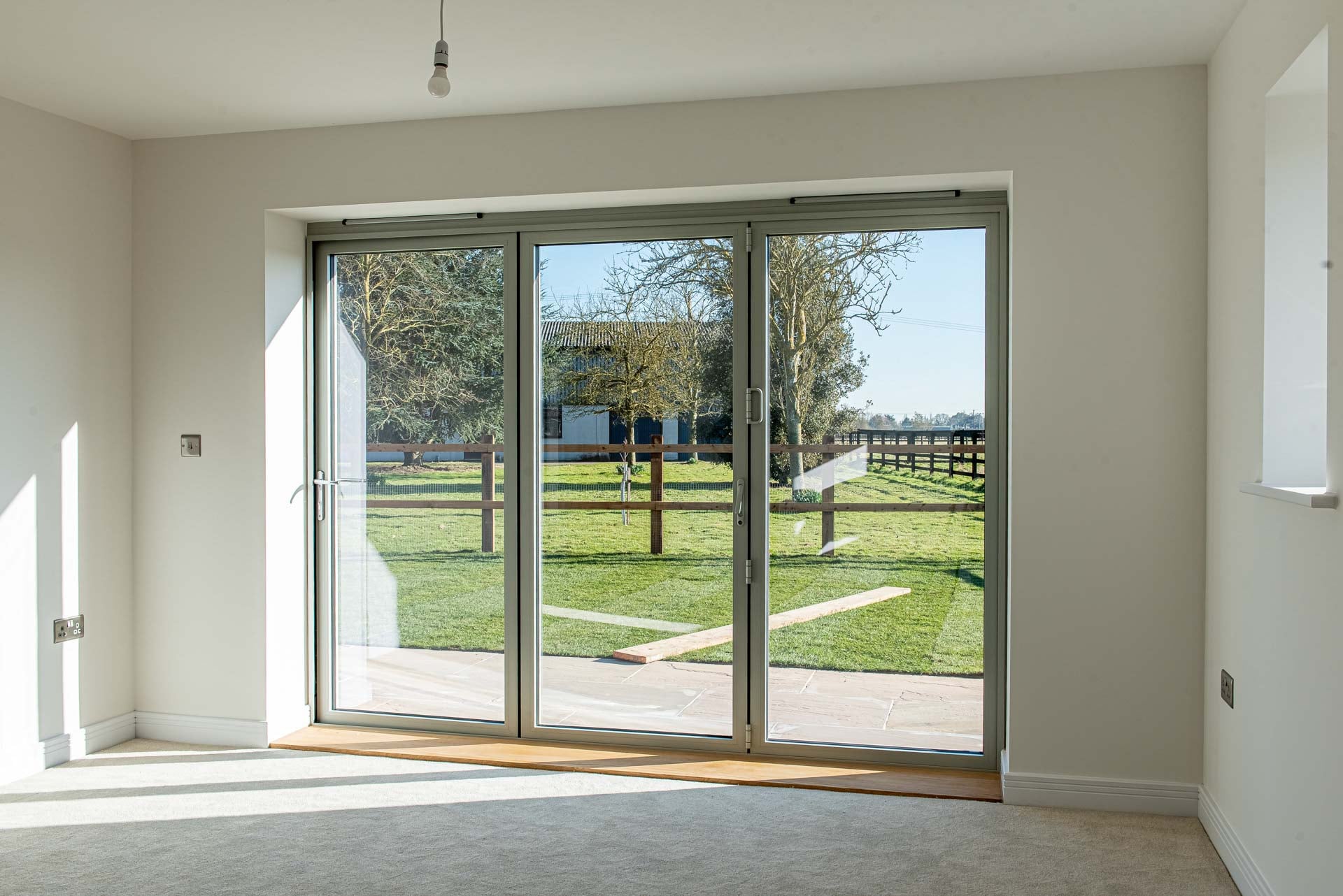 Interior view of Smarts aluminium bifold doors with white internal finish